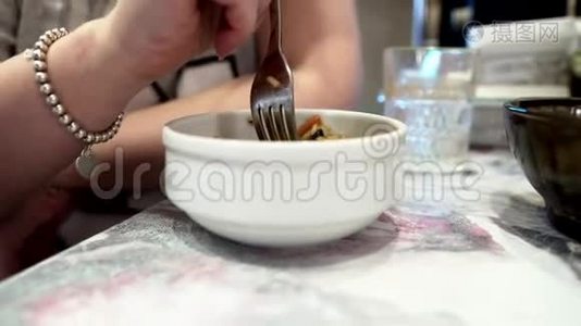 一个坐在厨房桌子旁吃米饭的女人。 美味的早餐。视频