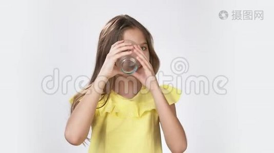 一个女孩的肖像，表现出有趣的情绪，手里拿着一个杯子。 小女孩的情绪。 一个女孩的肖像视频