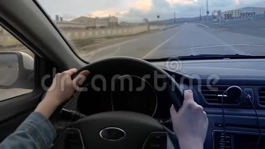 女性手在移动汽车方向盘上的垂直射击视频