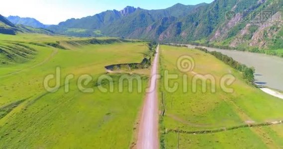 阳光明媚的夏季早晨，空中乡村山路和草地。 沥青公路和河流..视频