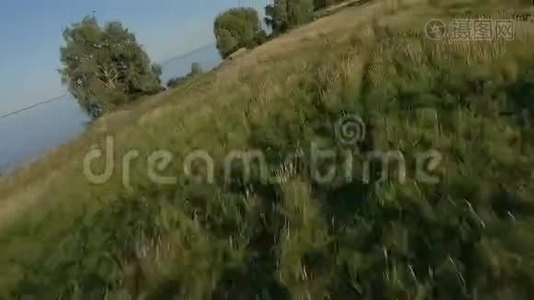 FPV无人机赛车视野。 在土路和田野上的动态飞行视频