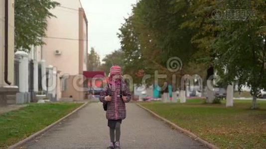 带眼镜的女学生放学回家。 那个女孩跑得很高兴。视频