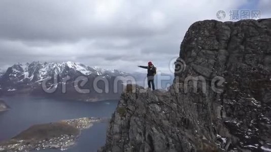 台湾群岛风景秀丽的洛佛顿群岛风光，山顶上男性徒步旅行者的空中镜头视频