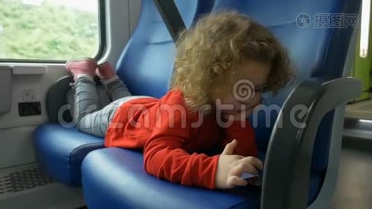 火车上的孩子看智能手机视频