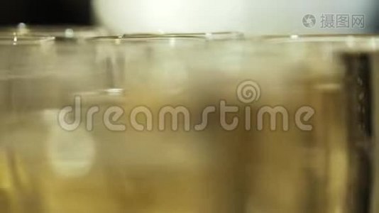 近景模糊的香槟酒杯与凉爽美味的香槟或白起泡酒在桌子上。 行动视频