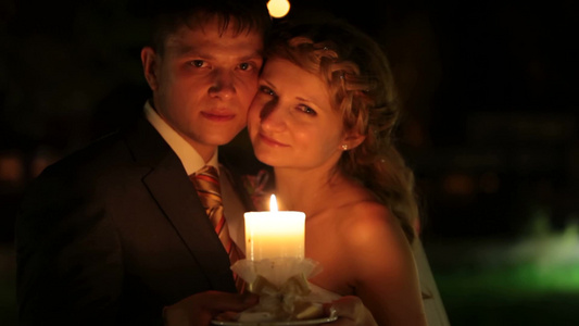 捧着蜡烛的新娘和新郎拥抱在一起视频