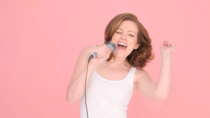 女人在粉色的背景下唱歌10秒视频