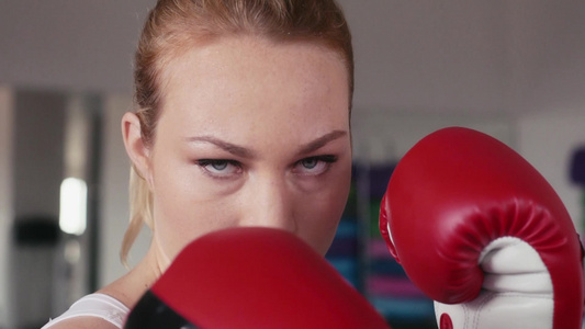 在健身俱乐部年轻的女人做拳击自卫肖像看相机视频