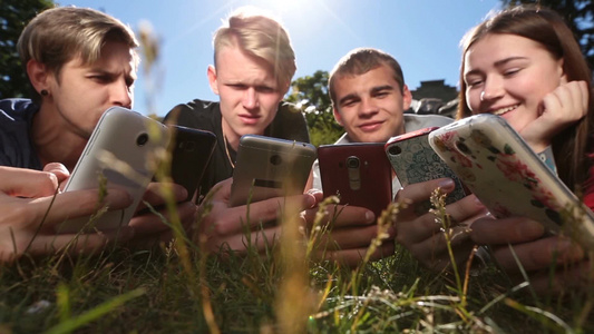青少年朋友们聚集操作智能手机[基本操作]视频