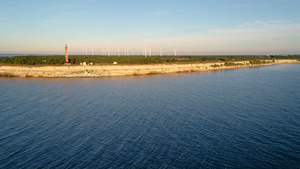 日落时半岛上的旧灯塔和风力发电机15秒视频