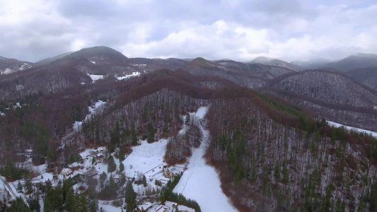 冬季穿越村庄雪地森林山峦视频