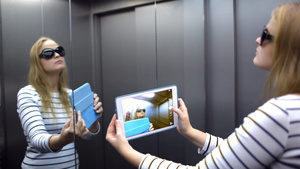 电梯里的年轻女人用触控板拍她自己的照映电梯墙上的滑稽照片15秒视频