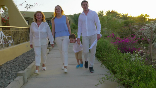 年轻父母与小儿子和祖母走在户外度假村散步视频
