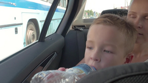 妈妈抱着小男孩在车子里喝水21秒视频