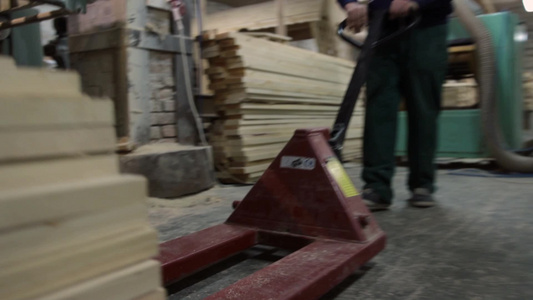 在堆叠的木板车间木工在推装有木板的叉车视频