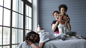 快乐的混合种族家庭在卧室享受幸福时光22秒视频