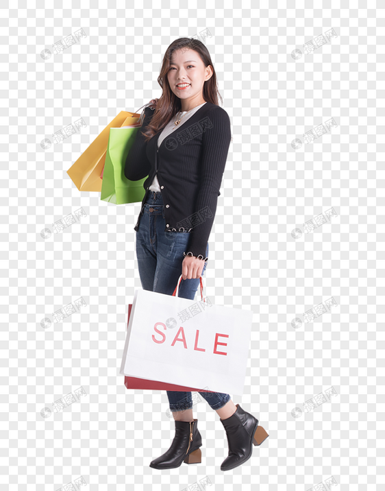年轻女性提着购物袋走路图片