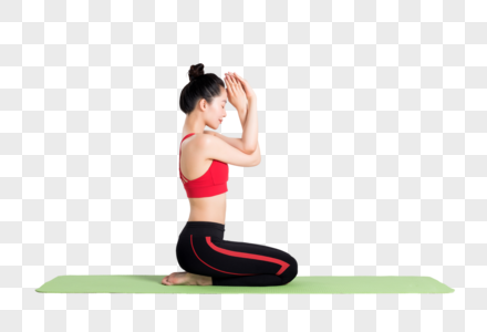 坐在瑜伽垫上做瑜伽动作的女性高清图片