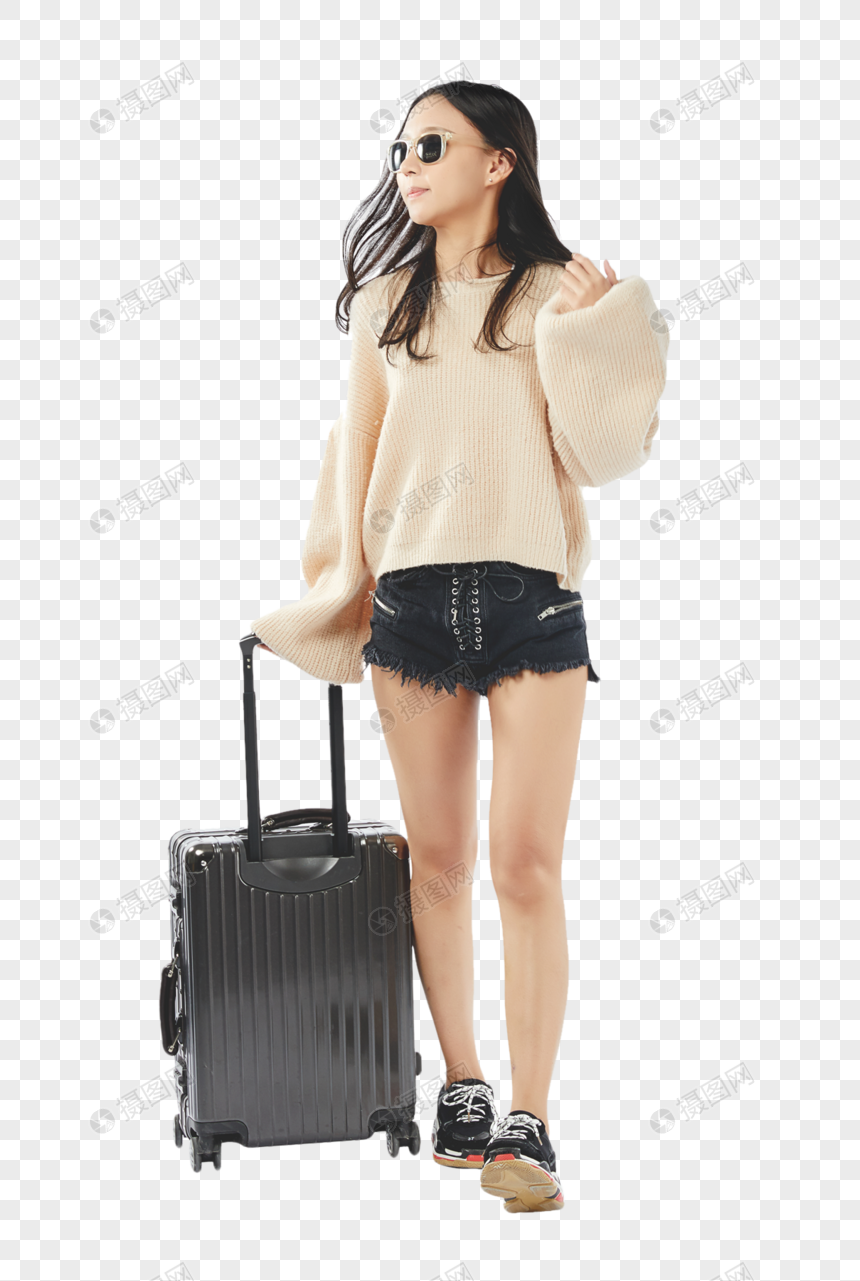年轻女孩拖着行李走的动作图片