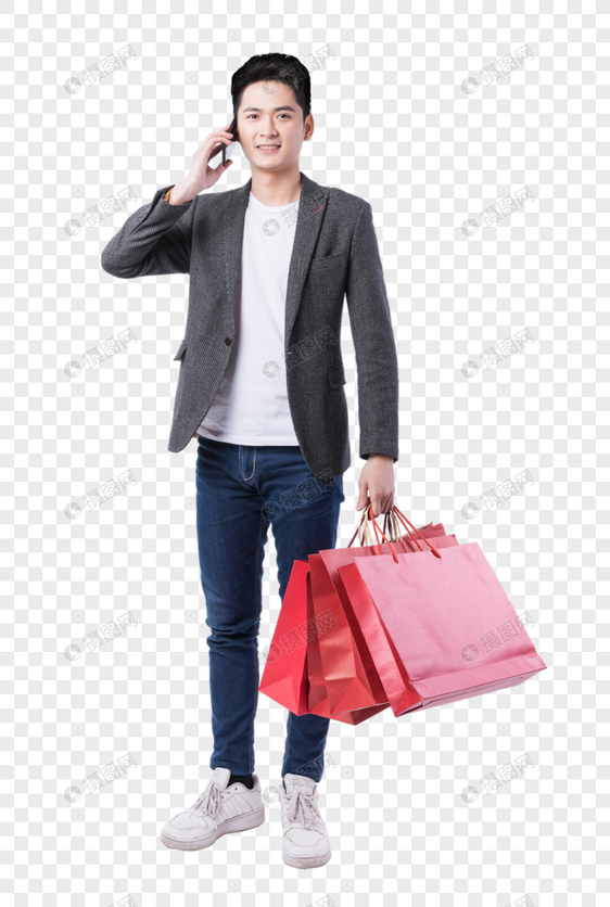 提着购物袋打电话的年轻男性图片
