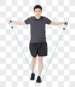 青年男子使用阻力带健身塑身高清图片