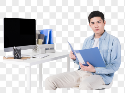 年轻男性坐在办公桌前工作图片