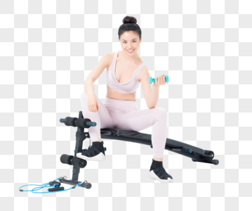 坐在仰卧板上锻炼的运动女性图片