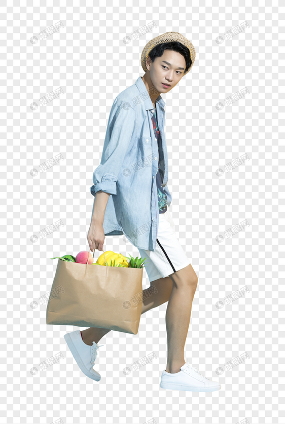拿着一袋水果的青年男性图片