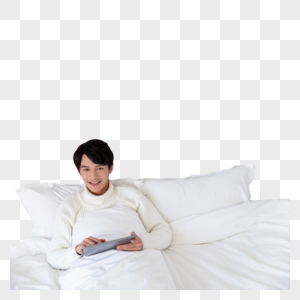 青年男性躺在床上使用平板电脑图片