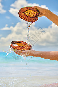 女人马赛尔的海滩上用椰子泼水图片