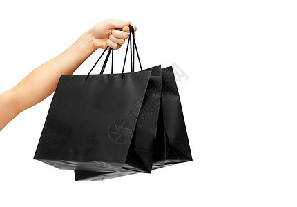 零售黑色星期五销售女手黑色购物袋白色背景女手着黑色购物袋图片