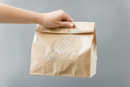 回收生态手次棕色外卖食品纸袋午餐桌子上手外卖食品纸袋午餐背景图片