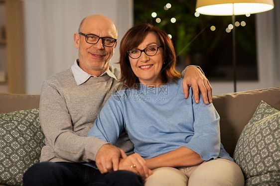 关系,老年人的快乐的微笑老年夫妇拥抱沙发上家里晚上幸福的老年夫妇家里沙发上拥抱图片