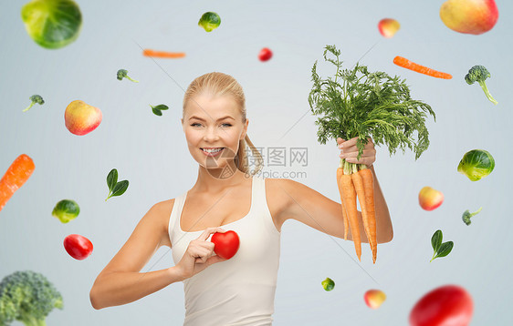 健康的饮食,食物饮食快乐的微笑年轻女人抱着红心胡萝卜快乐微笑的年轻女人带着心胡萝卜图片