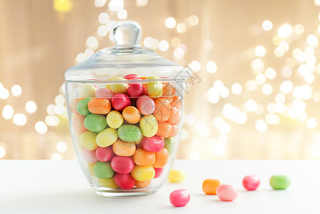 食物,糖果糖果的璃罐与五颜六色的糖果滴节日的灯光背景璃罐与糖果图片