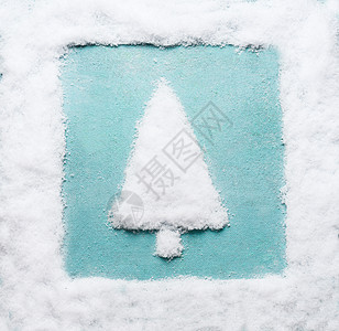 圣诞树用雪做的,背景蓝色的雪框现代创意寒假背景图片