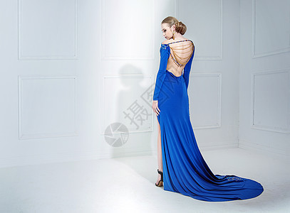优雅的女人穿着豪华的蓝色长袍图片