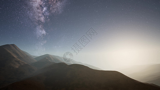 沙漠山脉上方的银河系恒星图片