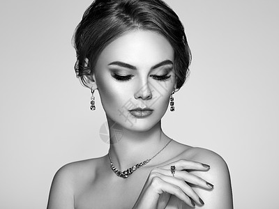 用珠宝描绘美丽的女人模特女孩,指甲上有华丽的指甲优雅的发型时尚化妆箭头美容配饰图片