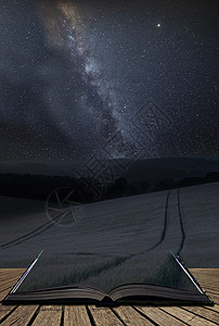 令人震惊的充满活力的银河复合图像夏季麦田的景观上页开放的故事书中出来图片