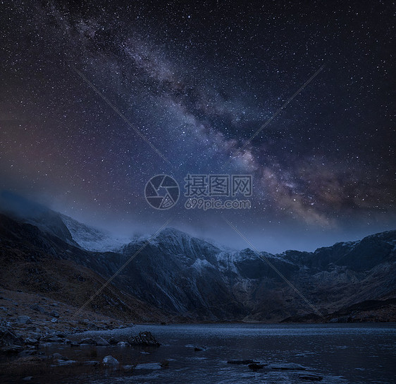 夜间白雪覆盖山脉冬季景观的次复合图像,上面有银河图片