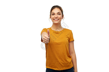 手势人的快乐微笑的轻女人十几岁的女孩穿着橙色的t恤,白色的背景上竖大拇指穿着T恤的女人十几岁的女孩竖大拇图片
