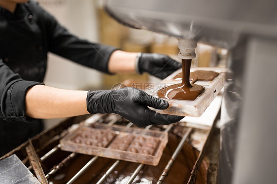 生产,烹饪人们的糖果填充糖果模具与巧克力糖果店糖果师糖果店巧克力糖果图片