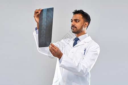 医生背景医学,医疗人的印度医生灰色背景下看脊柱X线印度医生看脊柱X光背景