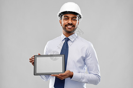 建筑,技术,建筑业务建筑微笑的印度建筑师商人头盔与平板电脑灰色背景建筑师商人头盔与平板电脑图片