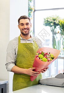 小生意,销售花卉快乐微笑花店与花微笑的花店老板带着花店图片