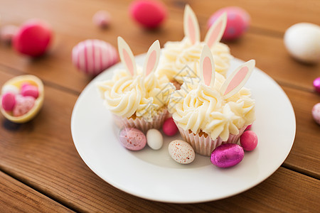 复活节,食物假日木桌上彩色鸡蛋糖果的磨砂纸杯蛋糕桌上复活节鸡蛋糖果的纸杯蛋糕图片