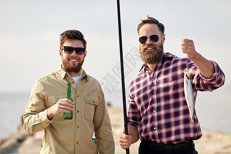休闲人们的快乐的朋友与鱼竿,鱼啤酒码头海上码头上钓鱼竿啤酒的快乐朋友图片