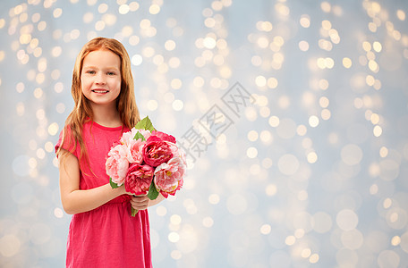 童人们的快乐的红头发女孩与花节日的灯光背景快乐的红头发女孩,花灯光上图片