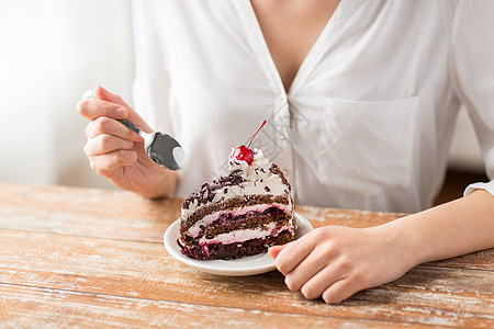 食物,甜点糕点的接近妇女吃块巧克力层蛋糕与马拉西诺樱桃女人吃樱桃蛋糕图片
